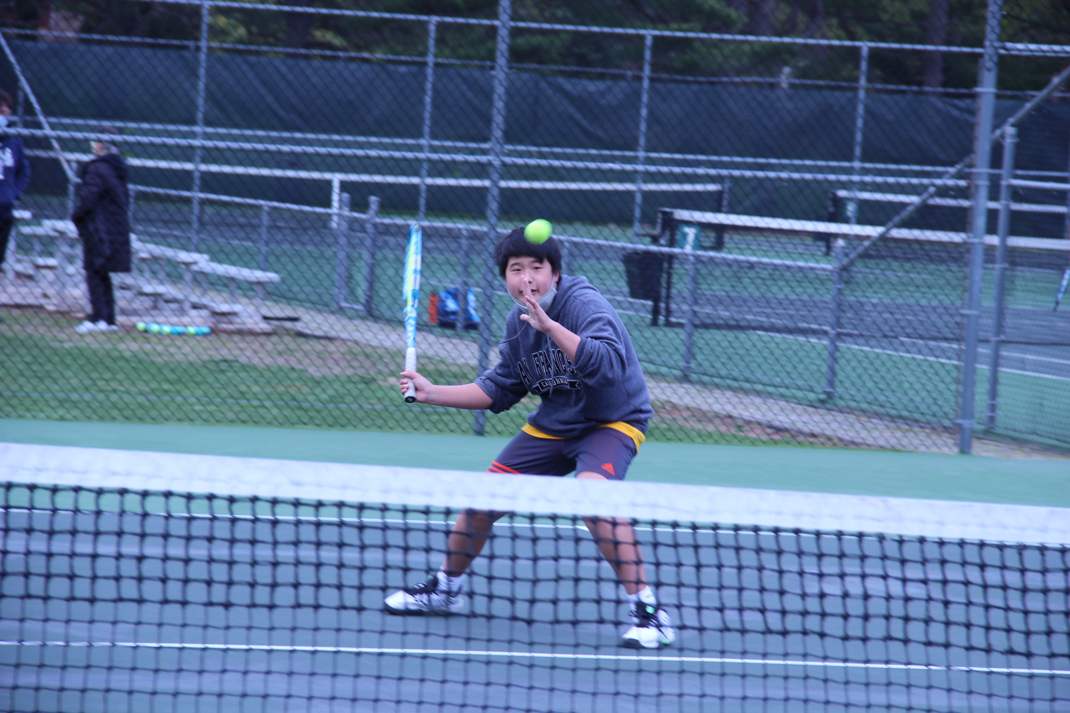 Student playing tennis